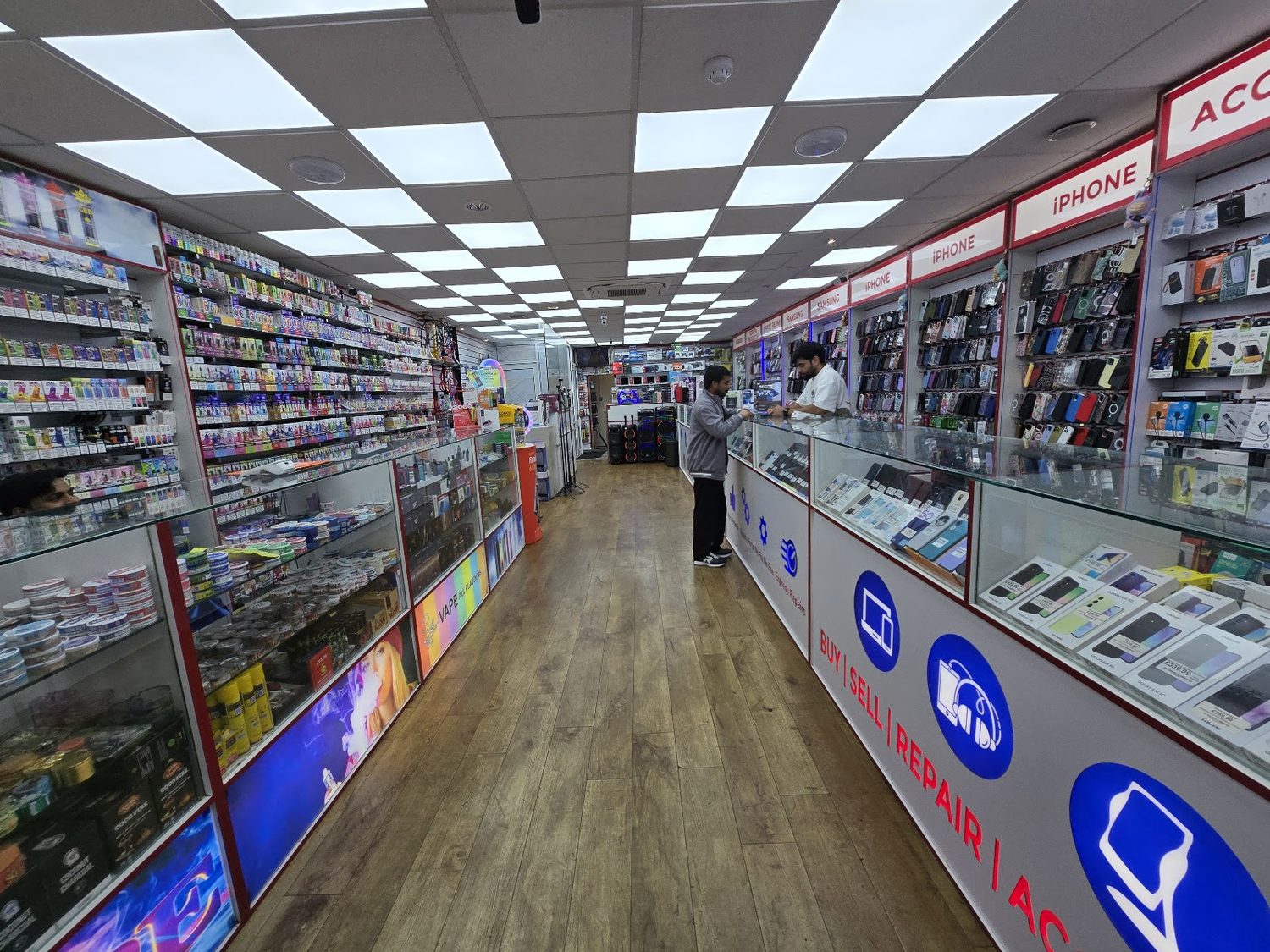 Inside Ilford Gadgets — the repair and accessories counter with iPhone and Samsung cases on the wall.